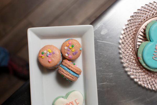 colorful cookies and macarons on plates 