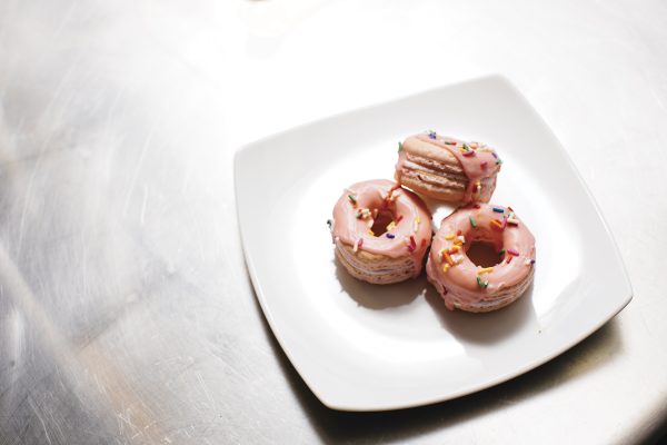 pink, doughnut-looking macarons on plate
