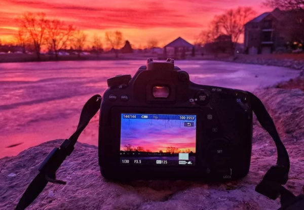 camera on rock at sunset