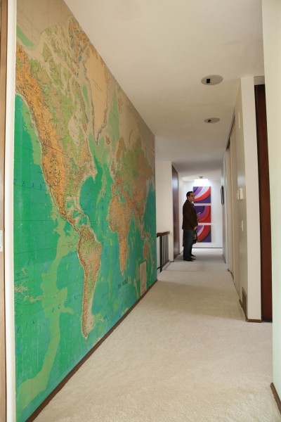 A wallpaper map of the world, installed by Polsky, lines the main hall.
